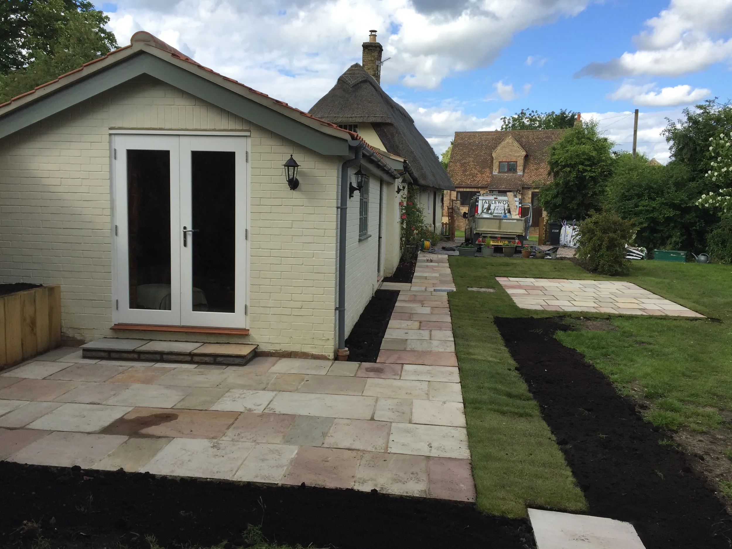 Completed outbuilding beside a listed thatched cottage